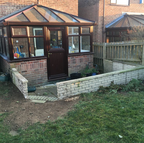 Ivy arch job completed. All waste removed from site revealing a brick wall.