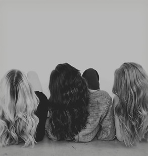 a group of three women sitting next to e