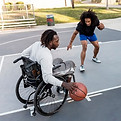 disabled-man-wheelchair-playing-basketball-with-his-friends-outdoors-bis-1.jpg