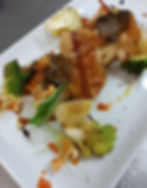 Tronchetto di spigola in fascia di parmigiano con guanciale croccante e tartufo