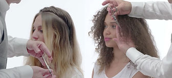 Two models getting curly cut done to their hair