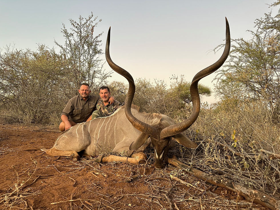 A proud hunter poses with a magnificent trophy kudu, taken on a successful hunt at Farm Helena, Freja Odla Safaris.