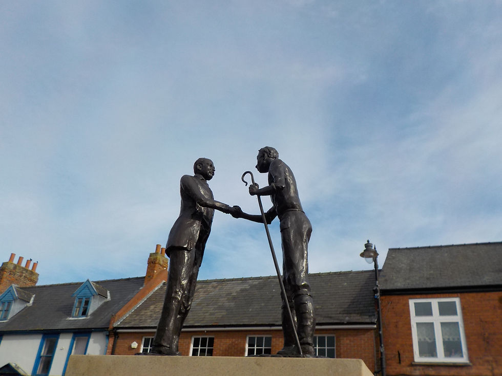 Statue of farmer and farm hand shaking hands