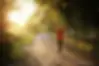 Girl walking on trail at sunset