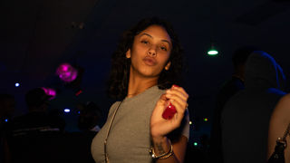 Woman doing duck lips in a dark club
