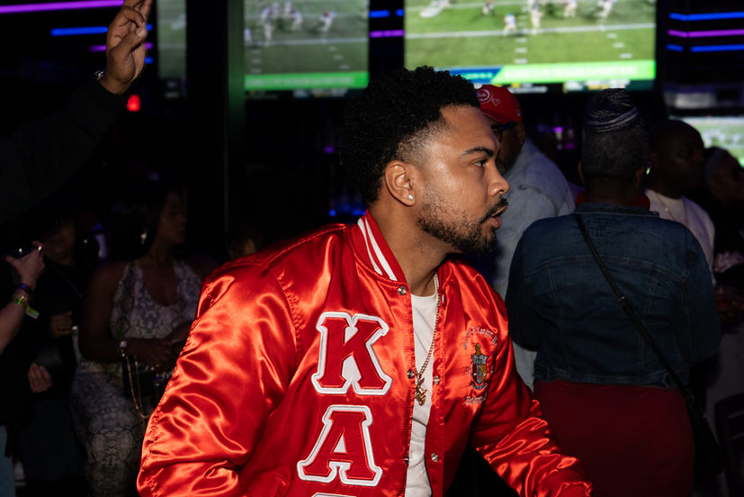 Man in red satin jacket with KA letters