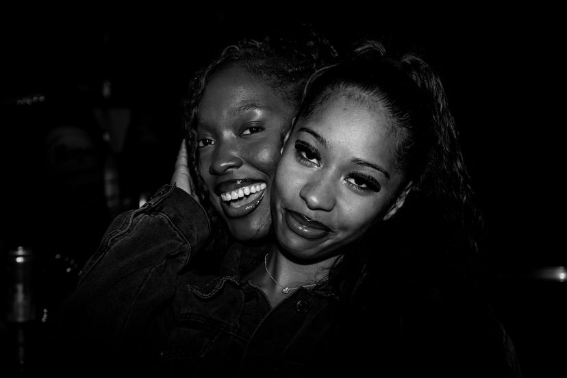 Two women smiling in black and white