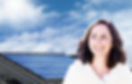 Headshot of woman in front of solar panels installed on residential roof