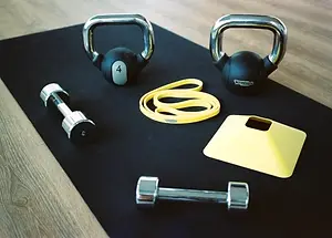 rehabilitation equipment including kettlebell dumbbell and elastic band used in physiotherapy sessions