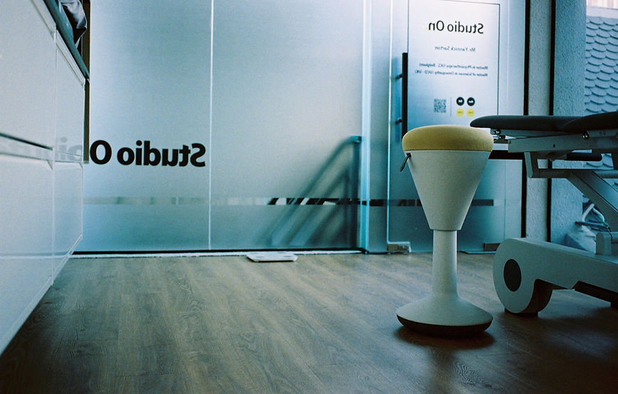 Modern clinical stool inside a bright physiotherapy consultation space