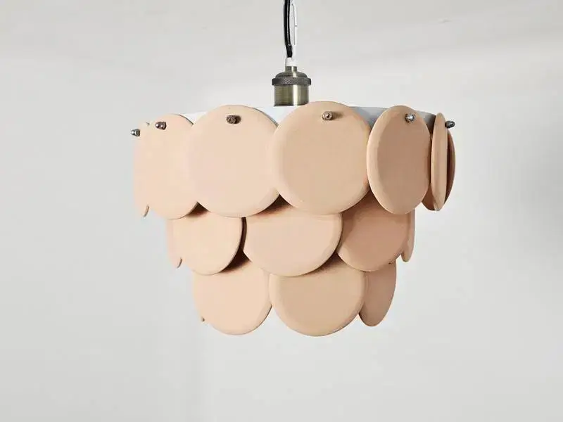 Thumbnail: Warm, diffused light radiating beautifully through the overlapping sculptural discs of a modern luxury chandelier.
