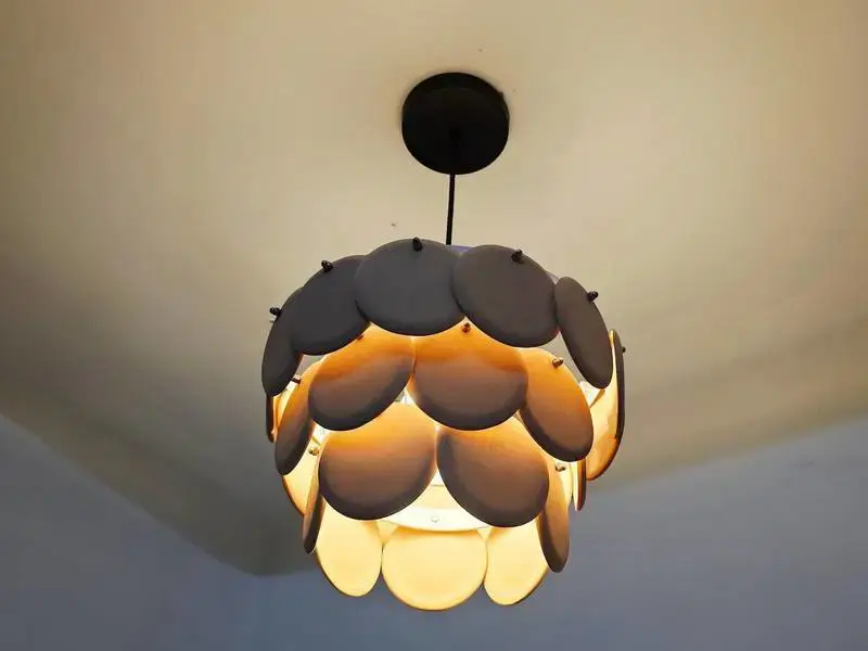 Thumbnail: Elegant cascading disc chandelier emitting a cozy, ambient glow from within its sculptural organic form.