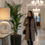 Thumbnail: White sculptural lamp casting an inviting halo in a grand, chandelier-lit corridor.