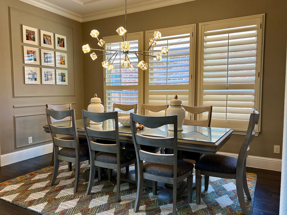 Elegant modern living and dining room with neutral tones, wall decor, and gold chandelier by CoziZone Interior Design.