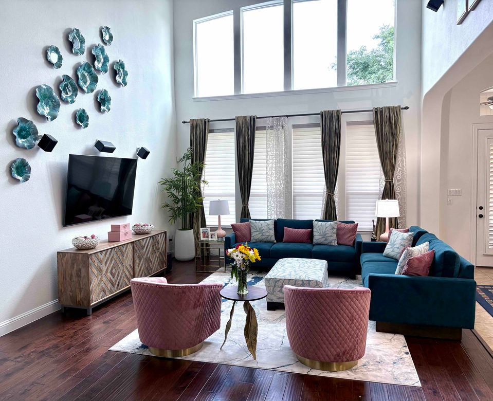 South Asian luxury living room with teal sectional, pink velvet chairs, and accent wall decor by Indian interior designer in Frisco, Texas