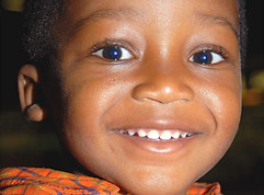 Close-up of 2-year-old West African boy smiling at the camera