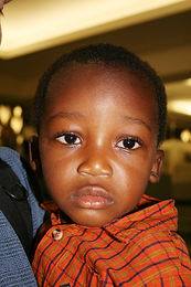 Close-up of 2-year-old African boy looking focused at the camera