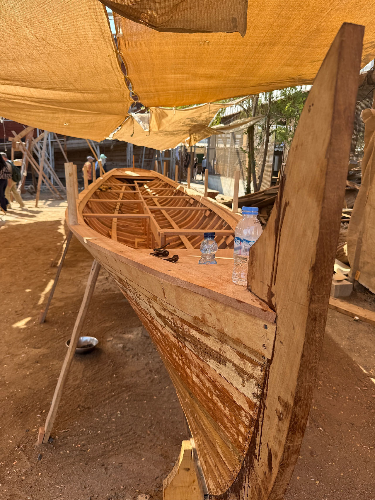 a small wooden boat in the traditional shipyard in Sur
