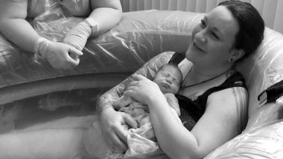 Licensed midwife providing water birth support at Beautiful Mountain Birth's Draper, Utah birth center