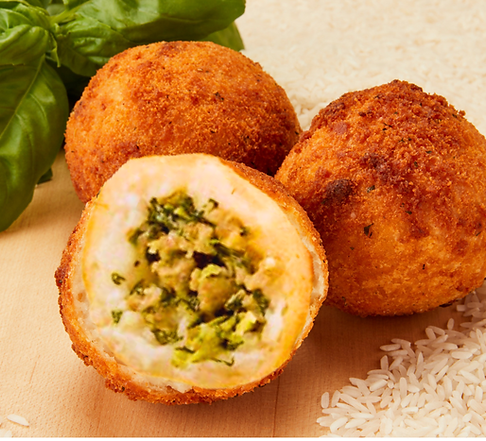 Three Arancini Sausage & Broccoli Rabe on the wooden board with basil behind and rice on the front right.