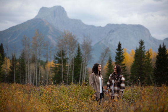 The mood reflects the fall colours before sunset while Dev and Kiersten hold hands in their brown acsent close to match the fall