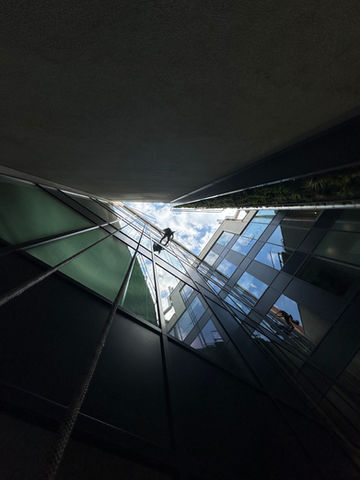 Art of Alpine rope access technician performing building maintenance