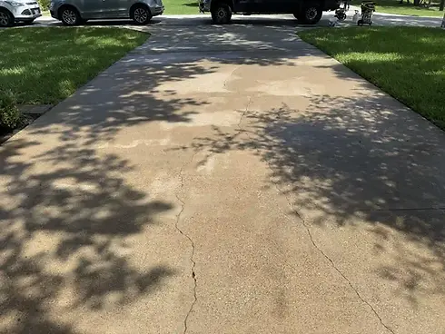 Freshly pressure washed concrete driveway at a Richardson, TX home with restored color and a clean surface.