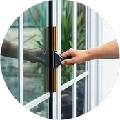 Hand cleaning a window in West Plano.