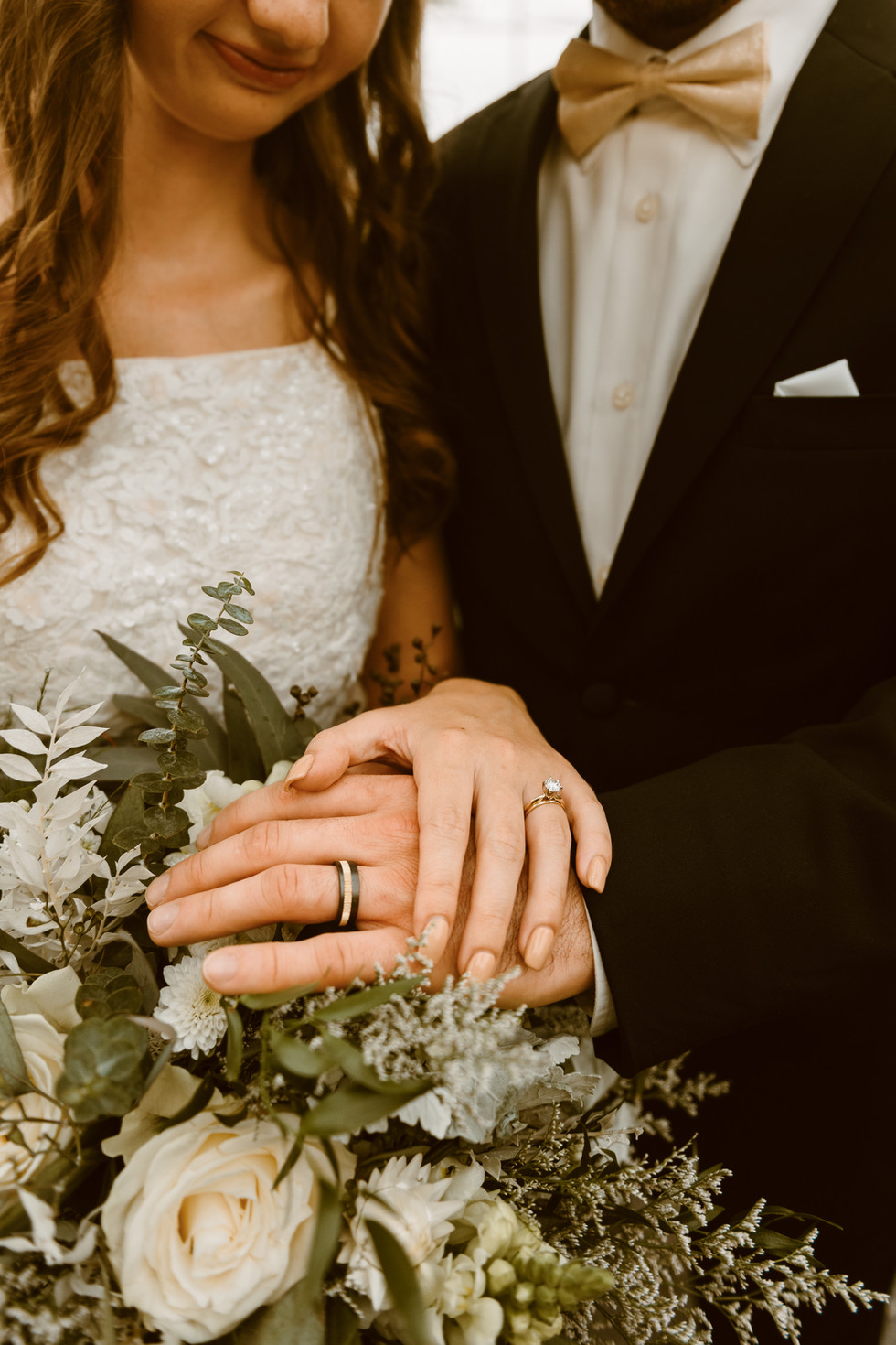bride and groom posing inside boho greenhouse wedding venue