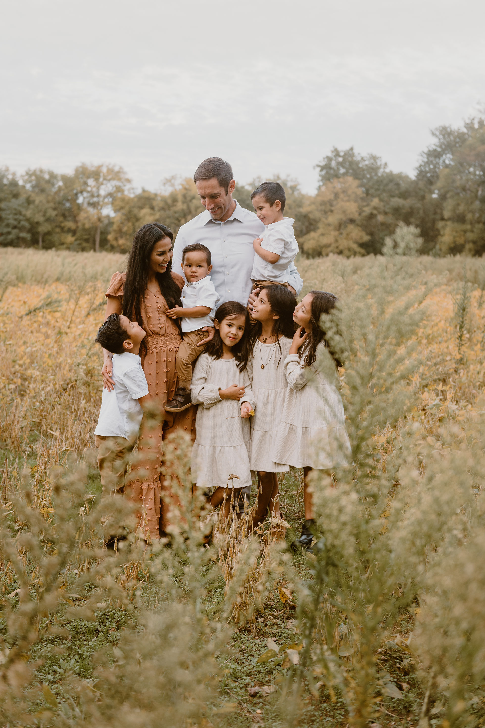 family getting pictures taken at a local park in the fall