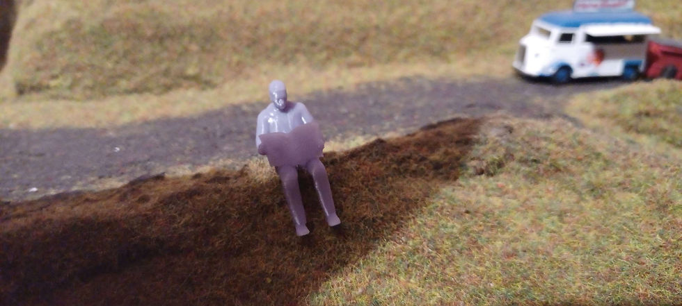 Thumbnail: Fig: BR80: Bare Resin man sitting reading the newspaper