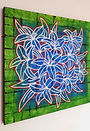 side view of a painting of lue lilies on a green background
