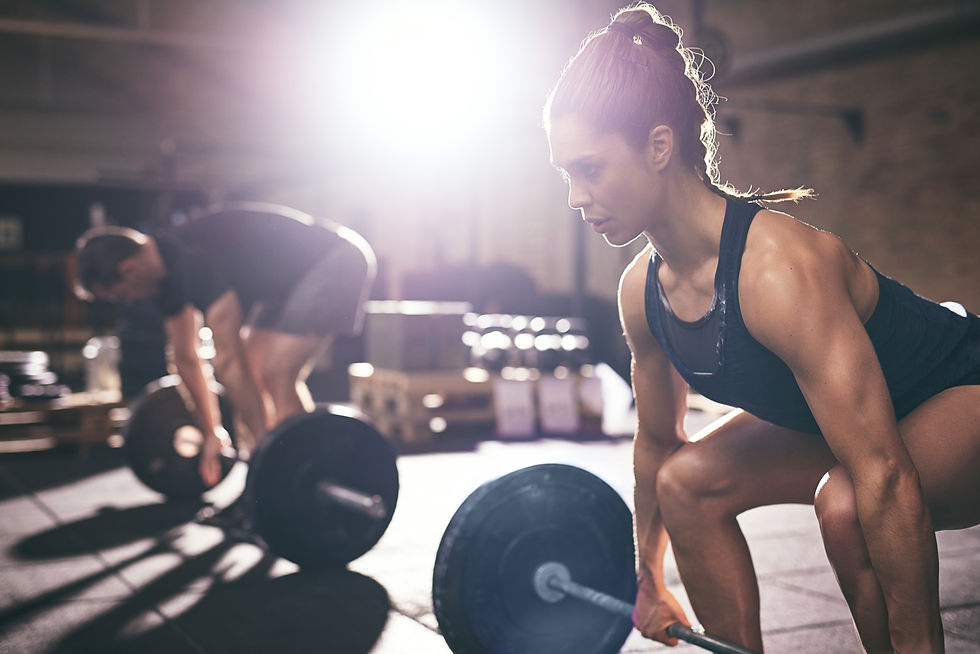 Woman and man lifting heavy weights