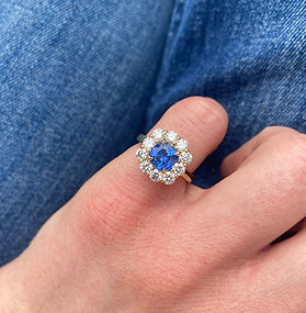 Blue sapphire and diamond cluster engagement ring