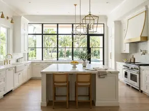 Luxury custom kitchen with white shaker cabinets, marble countertops, and premium appliances in a Palm Beach home.
