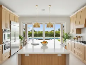 Completed luxury Palm Beach kitchen remodel with quartz island, custom cabinets, and indoor-outdoor living.