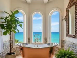 Copper freestanding bathtub installation in Palm Beach master bath with hurricane-resistant windows and ocean view