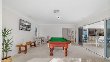 Ground-floor rumpus room opening to the outdoor area at River Road Villa House