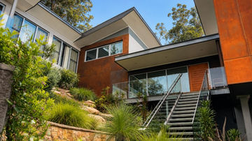 Treetops House entry stairs and split-level architecture on sloping bushland site