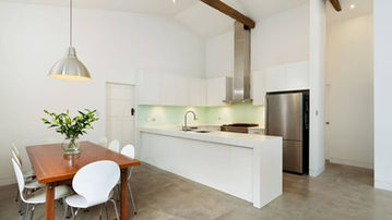 Contemporary kitchen and dining area with exposed timber beams at Creewood House