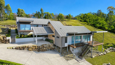 Elevated exterior view of Mulgoa House showing the home positioned across the steep acreage site