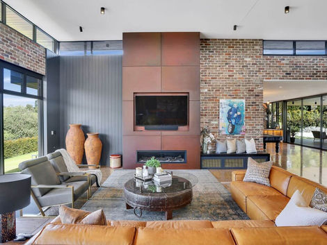 modern industrial corten fireplace exposed bricks tan leather lounge