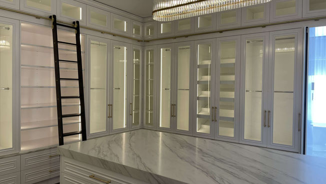 Custom walk-in wardrobe with marble island at Crawford Creek House