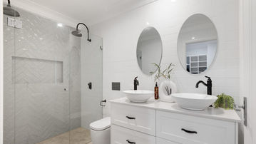 Contemporary bathroom with double vanity at River Road Villa House