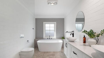 Renovated bathroom with freestanding bath at River Road Villa House