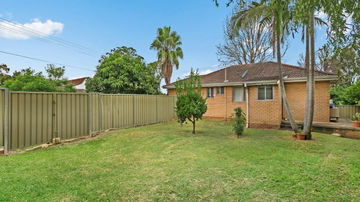 Rear yard and original home before the River Road Villa House renovation