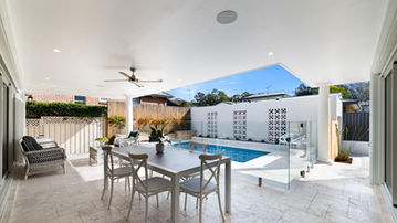 Covered alfresco area overlooking the swimming pool at River Road Villa House