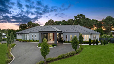 A statement acreage residence of scale and luxury, featuring resort-style entertaining, six bedrooms, and a separate, fully self-contained guest cabana. This custom design balances high-end family living with flexible, multi-generational accommodation.