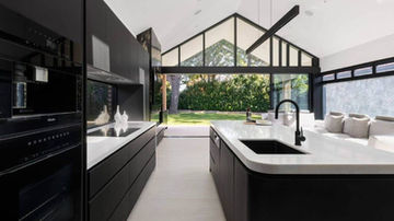 Kitchen interior looking towards the glazed rear extension at Salt Street House