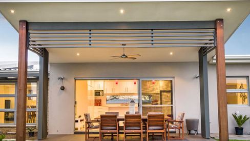 Covered outdoor dining area opening from the living spaces at Medinah House